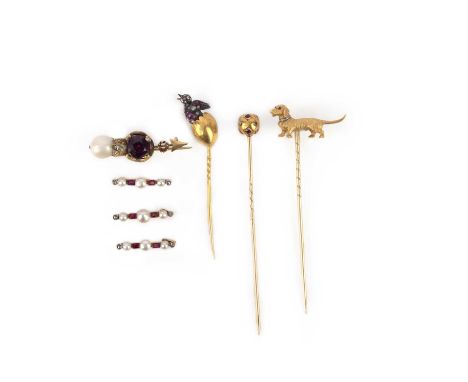 A collection of three stick pins and four brooches, early 20th century, comprising: three gold stick pins, capped respectivel