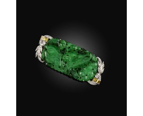 Birks, an early 20th century jadeite and diamond brooch, the carved jade depicting a butterfly amongst foliate, within scroll