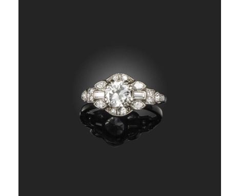 A diamond ring, mid 20th century, claw-set with a circular-cut diamond weighing approximately 1.00 carat, within a surround o