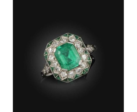 An emerald and diamond cluster ring, the step-cut emerald set within a border of diamonds and emeralds in an octagonal settin