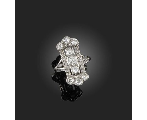 A diamond ring, early 20th century, of elongated plaque design, set with circular-cut diamonds, to fleur-de-lis shoulders, mo