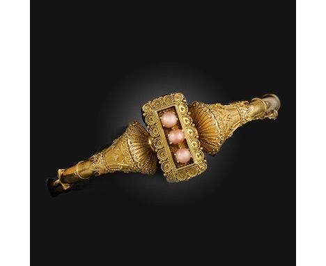 An Etruscan Revival gold bangle, late 19th century, with three coral cabochons in rectangular filigree gold surround and tape