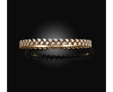 A diamond bangle, of hinged design, set with a continuous wreath of pear-shaped diamonds, totalling approximately 6.00 carats