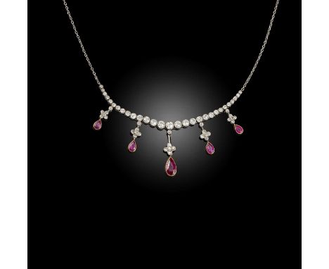 An Edwardian ruby and diamond fringe necklace, millegrain-set with graduated old circular-cut diamonds suspending diamond-set