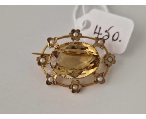 A oval brooch with large central citrine with floral pearl surround
