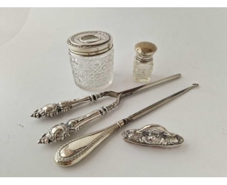 Two silver topped jars, a button hook etc