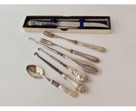 A silver handled bread knife, a button hook etc