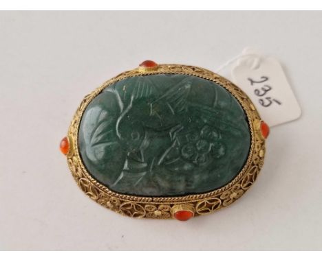 A large antique Chinese silver gilt carved jade panel brooch