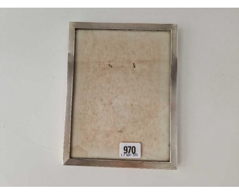 An oblong photo frame, engine turned, 8.5" high, Birmingham, 1956 by  HCD