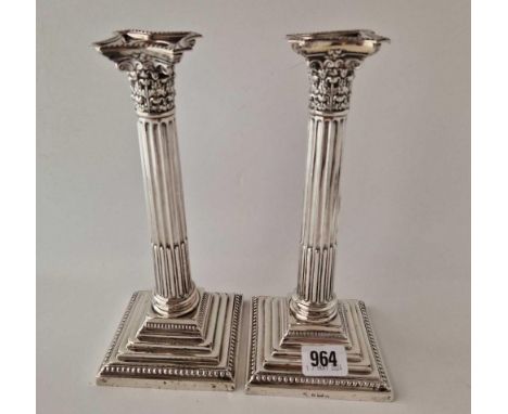 A pair of candlesticks with step square bases, fluted stems and detatchable nozzles, 9.5" high, Birmingham 1901
