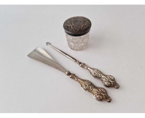 Embossed top jar, Birmingham 1899, a button hook and a shoe horn