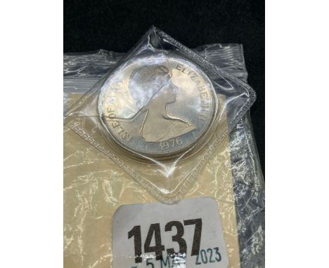 A 1976 silver proof 1-0-M crown with C.O.A