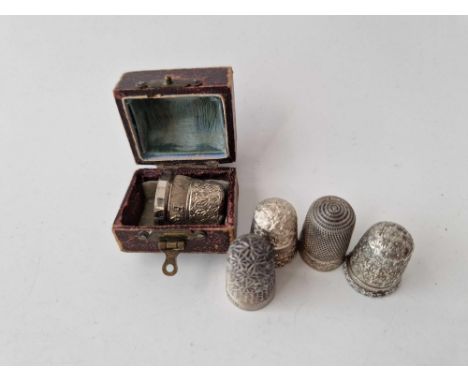 A boxed silver thimble and four other silver thimbles