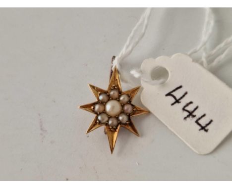 A small pearl star brooch set in 15ct gold
