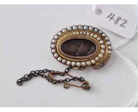 A 19th century pearl mourning brooch with gold snake pearl surround