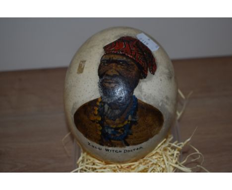 An ostrich egg, hand painted with a portrait of a Zulu Witch Doctor, measuring 18cm tall