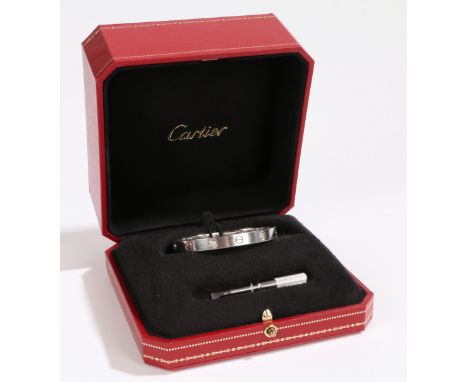 A Cartier 18 carat white gold and diamond love bangle, size 16, the bangle set with four diamonds and eight screw heads, no. 
