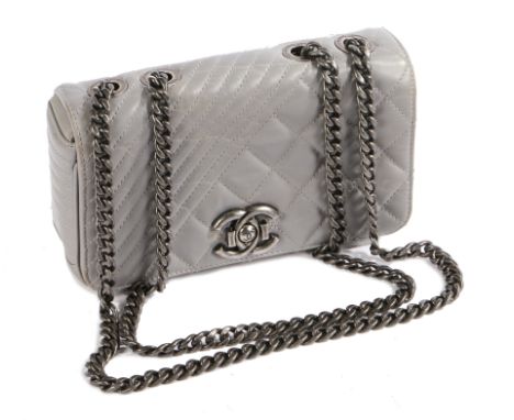 A Chanel Coco Boy small flap bag, with silver quilted leather exterior, the flap with CC push button clasp, silver chain-link