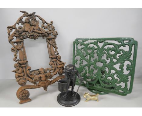 A Victorian cast iron picture frame, a cast iron music stand, a metal inkwell in the form of a man with a top hat and a small