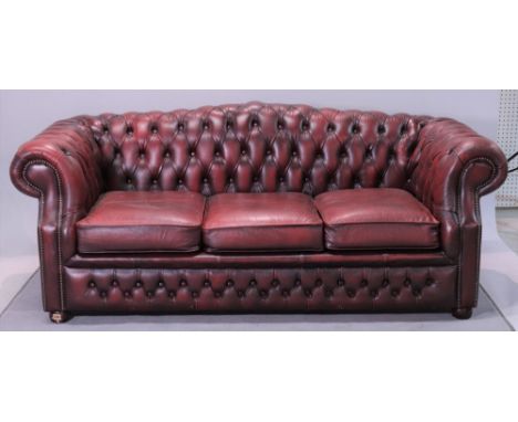 A modern hardwood framed chesterfield sofaWith faux red leather button back upholstery 195cm wide; 74cm highGood solid constr