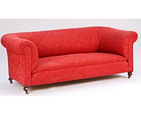 A late Victorian red upholstered Chesterfield style sofa on turned feet206cm wide; 76cm high