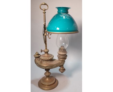 A late Victorian brass oil lampWith glass shade 55cm highSmall chips to the bottom rim of blue glass shade, metal ware itself
