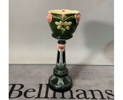 An early 20th century ceramic green and pink glazed jardinière on stand32cm diameter; 91cm highCondition: good general condit