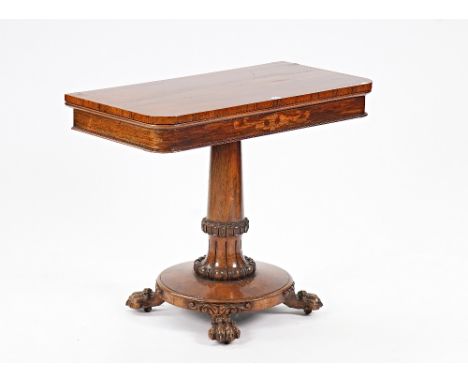 A William IV rosewood fold over card tableOn carved and turned column and four paw feet, 91cm wide; 73cm high