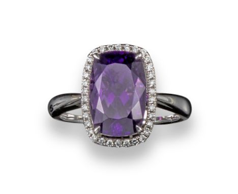 An amethyst and diamond cluster ring, set in white gold, stamped 4.11, size M