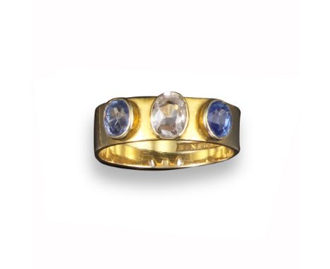 An Australian sapphire three stone ring by R H Parker, retailed by H Newman (1824 - 1913), the central oval white sapphire is