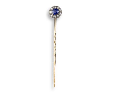 A sapphire and diamond stick pin, the circular-cut sapphire is set within a surround of diamonds in silver and gold, 8mm diam