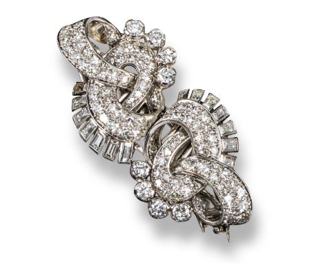 An Art Deco diamond-set double clip brooch, of scroll design, set with graduated circular-cut and baguette-shaped diamonds in