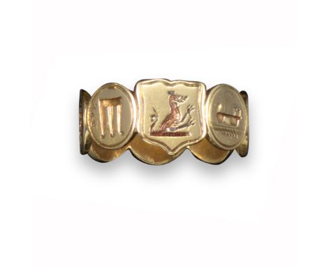 A gold ring comprising seven circular discs, each chased with a mythological-inspired design and centred with a shield-shaped