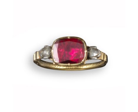An early 18th century English gold memorial ring, set with a flat oval garnet and two pear-shaped rose-cut shoulder diamonds,