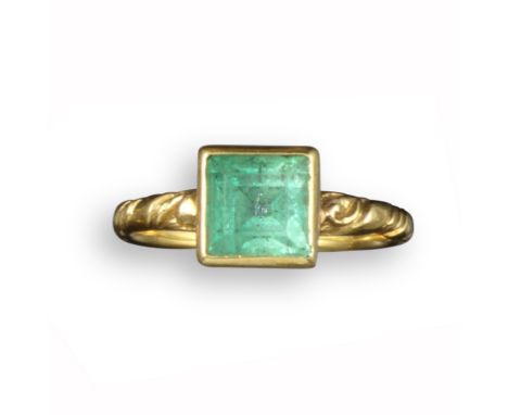 A mid 17th century emerald-set gold ring, possibly Spanish, set in a square collet with traces of white enamel to the scroll 