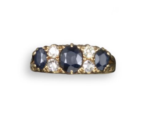 A Victorian sapphire and diamond half-hoop ring, set with three graduated oval-shaped sapphires and four cushion-shaped diamo