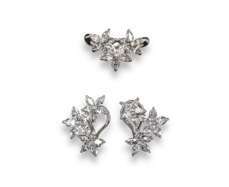 A pair of diamond flowerhead earrings by David Morris, set with graduated marquise-shaped diamonds forming a cluster of flowe