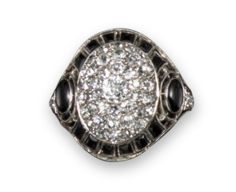 A French Art Deco onyx and diamond ring, the central bombe section pave-set with diamonds within pierced border of onyx caboc