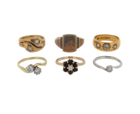 A group of six gold and gem-set rings, including a diamond two stone cross-over ring, size P, a diamond solitaire ring, size 