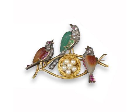 An early 20th century gold brooch, designed as three birds and a nest with eggs, two birds with carved brown-stone bodies and