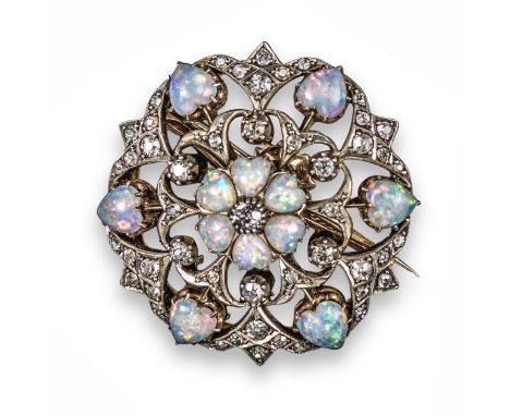 An Edwardian opal and diamond circular brooch pendant, centred with a circular-cut diamond within a heart-shaped opal surroun