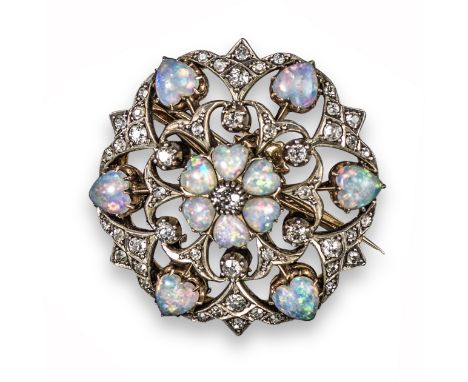 An Edwardian opal and diamond circular brooch pendant, centred with a circular-cut diamond within a heart-shaped opal surroun