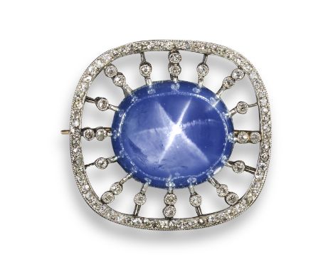An Edwardian star sapphire and diamond brooch, the high-domed cabochon sapphire is set within a surround of old circular-cut 