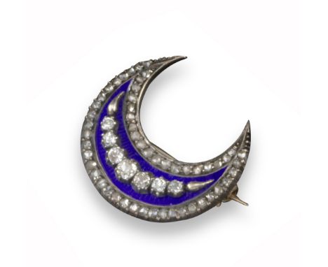 A late Victorian diamond-set crescent brooch, the closed crescent is set with a line of graduated cushion-shaped diamonds on 