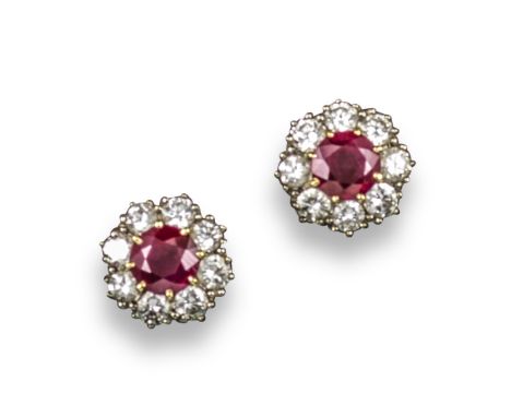 A pair of ruby and diamond cluster ear studs, the circular-cut rubies are set within a surround of circular-cut diamonds in y