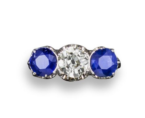 A sapphire and diamond three-stone ring, the old circular-cut diamond weighs approximately 1.08cts and is set either side wit