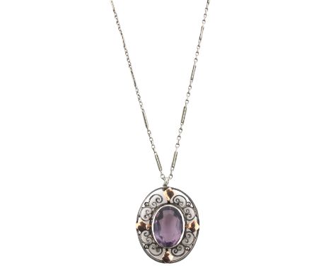 An Arts &amp; Crafts amethyst-set silver and gold pendant, the oval-shaped amethyst within scrolling silver border with gold 