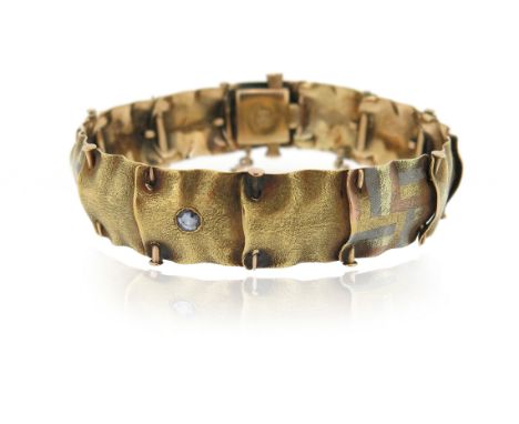 A textured gold bracelet attributed to A. J. Hedges &amp; Co., the square links with chequerboard decoration, the central pan