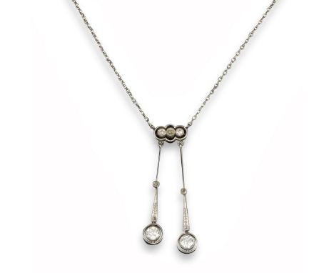 An Edwardian diamond pendant, the three graduated old cushion shaped diamonds suspend two larger old circular-cut diamonds in