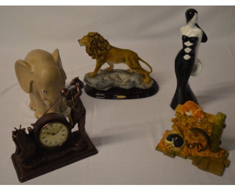 Various contemporary home decor including a Juliana golfing mantle clock and a resin figure of a lion
